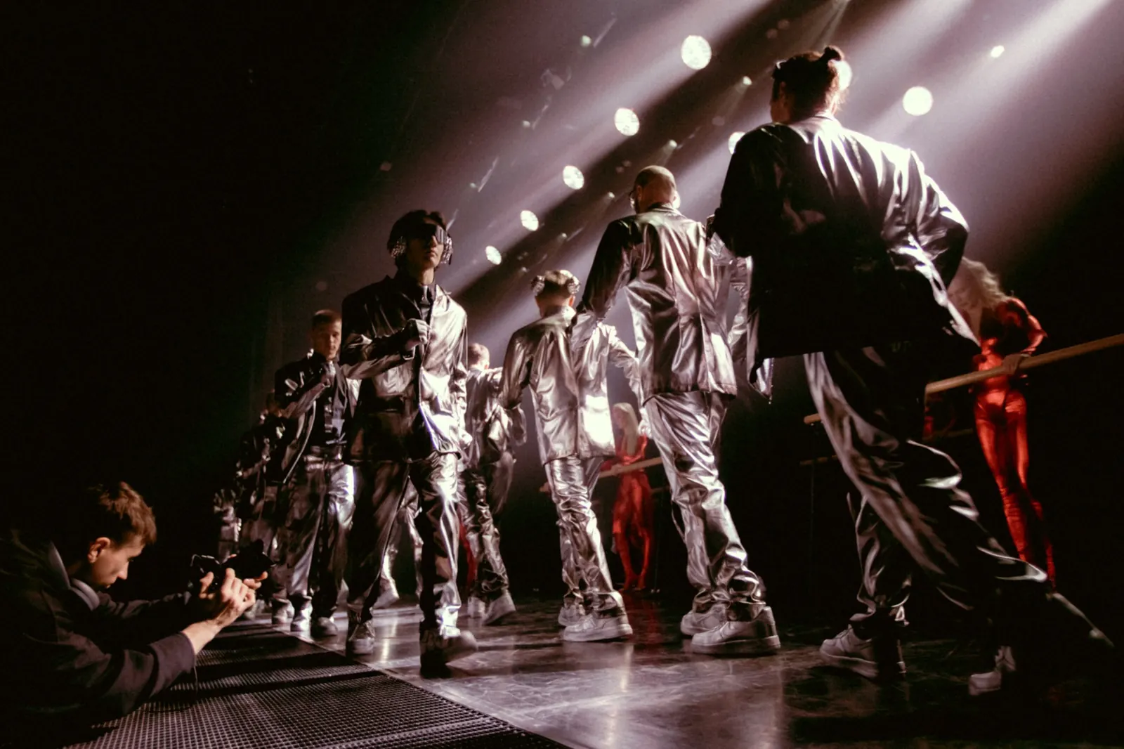 Camera operator filming performers on stage
